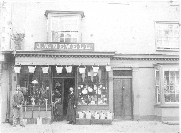 John W Newell outside his shop